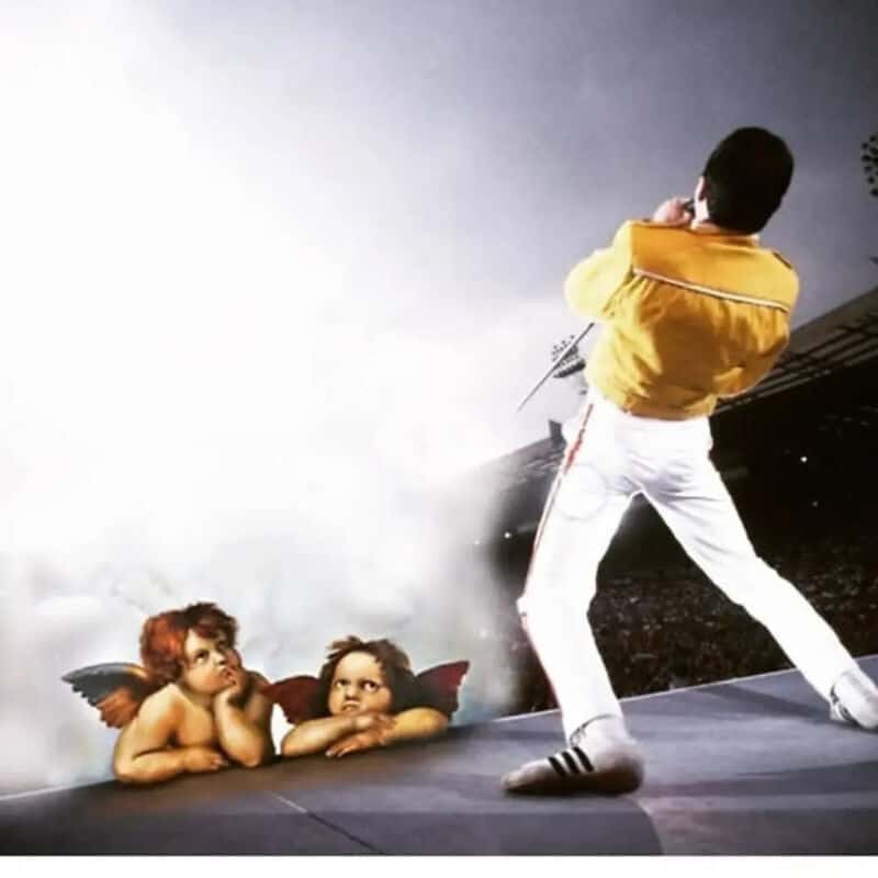 Elvis Presley performing on stage with two cherubs below him.