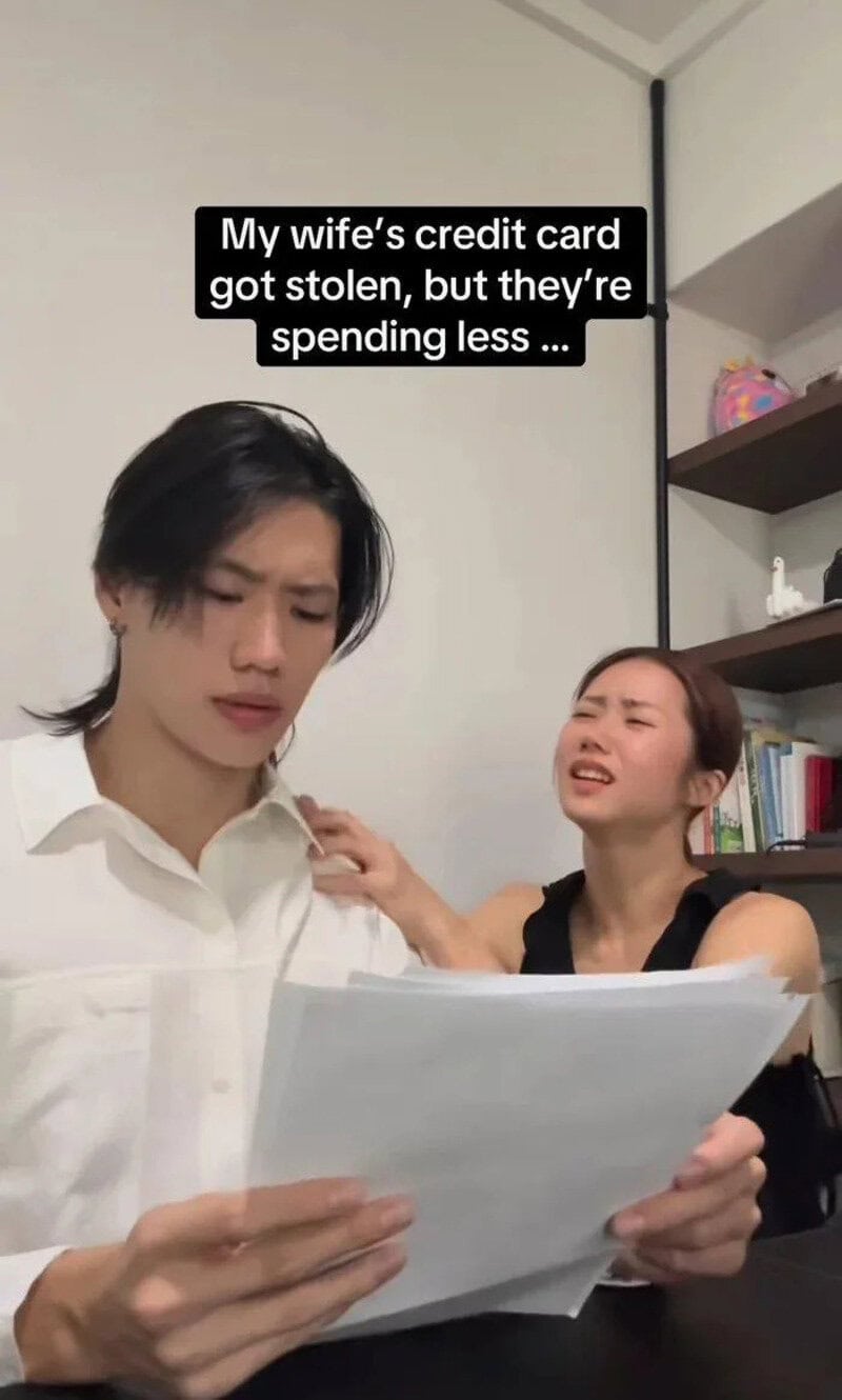 Couple looking at a document with a caption about stolen credit card and spending.
