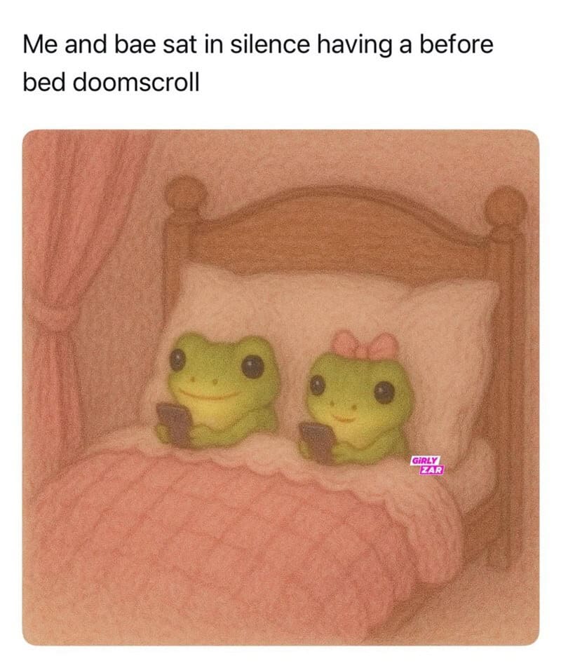 Two frogs with phones in bed, one with a pink bow, in a cozy bedroom.
