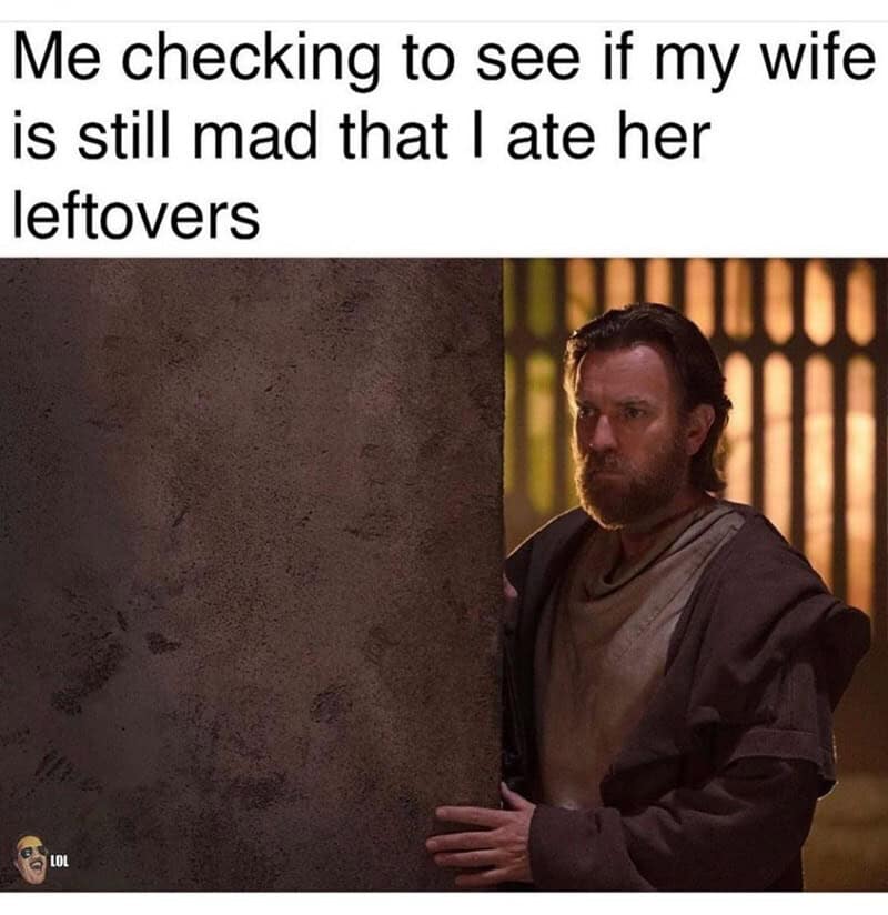Man peeking from behind a wall with the caption about checking if wife is mad over leftovers.