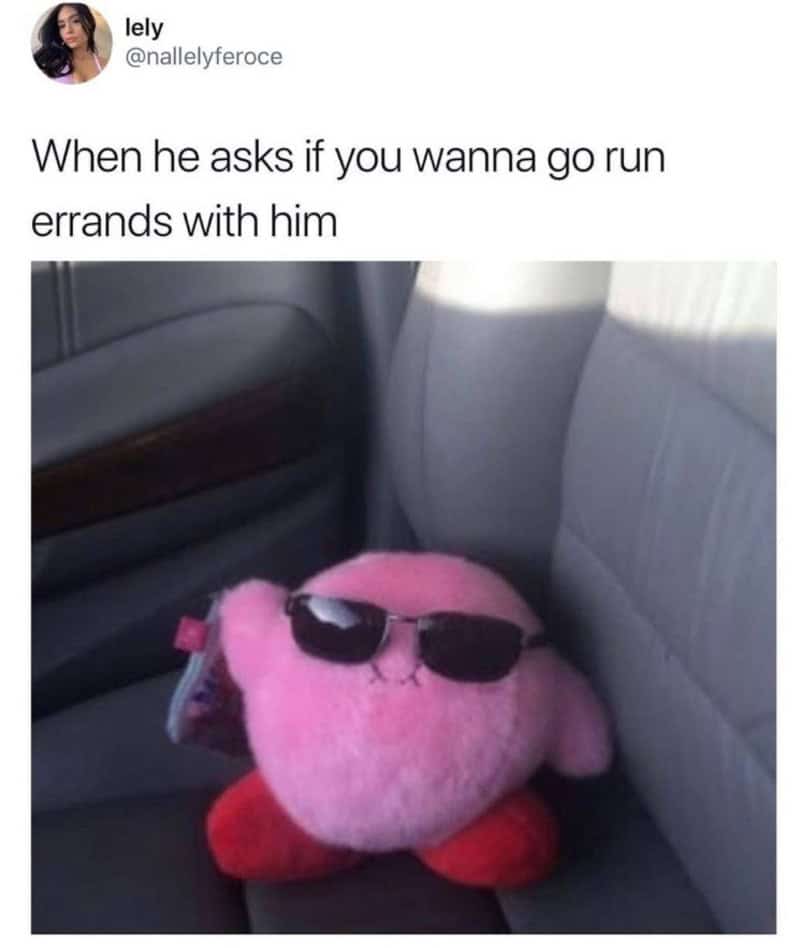 Pink plush toy with sunglasses sitting in car seat, caption about running errands.