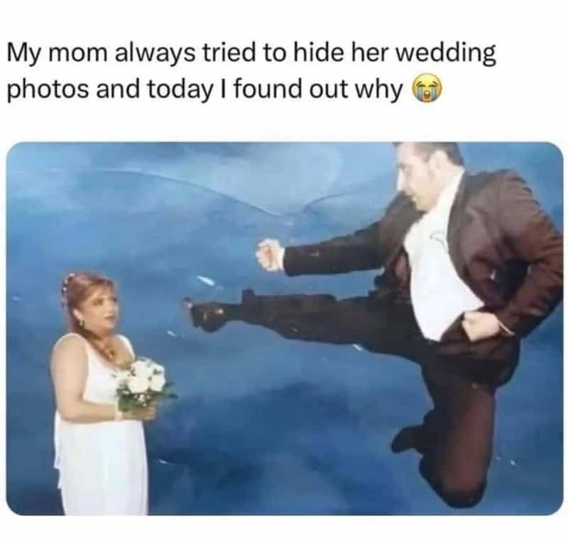Humorous wedding photo with a man kicking a woman in a wedding dress.