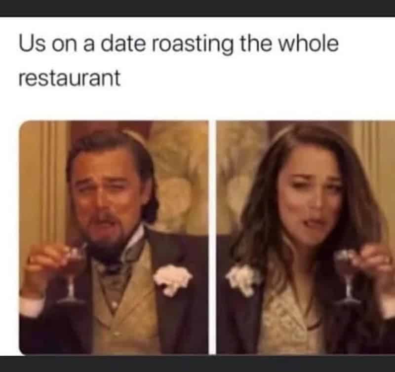 Couple at a restaurant, man and woman, both holding wine glasses, with humorous expressions.