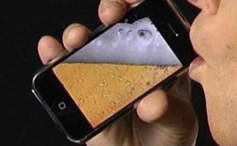 Person holding a smartphone with a beer foam pattern on the screen.