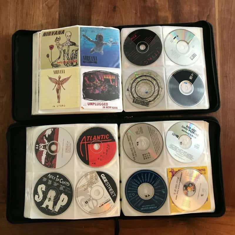 Collection of Nirvana CDs and album covers in a CD case.