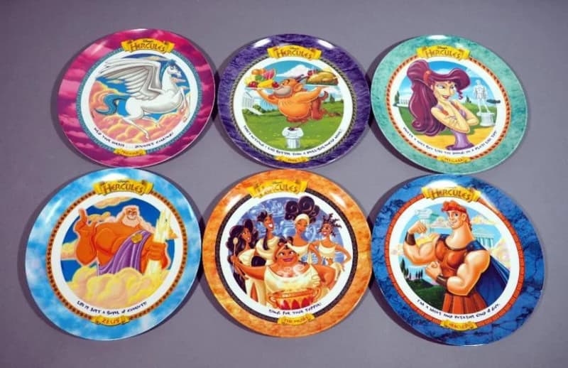 Six colorful vintage cereal bowl lids with cartoon characters from the 90s and 2000s.