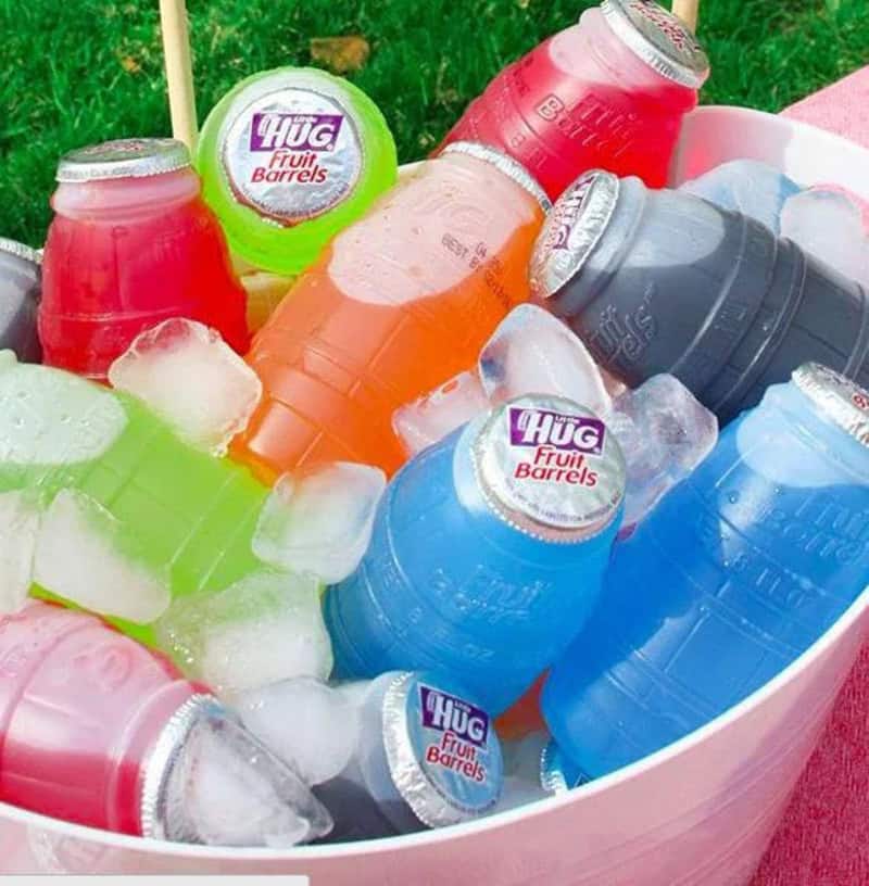 Colorful Hug Fruit Barrels and ice in a pink container, nostalgic for 90s-2000s.