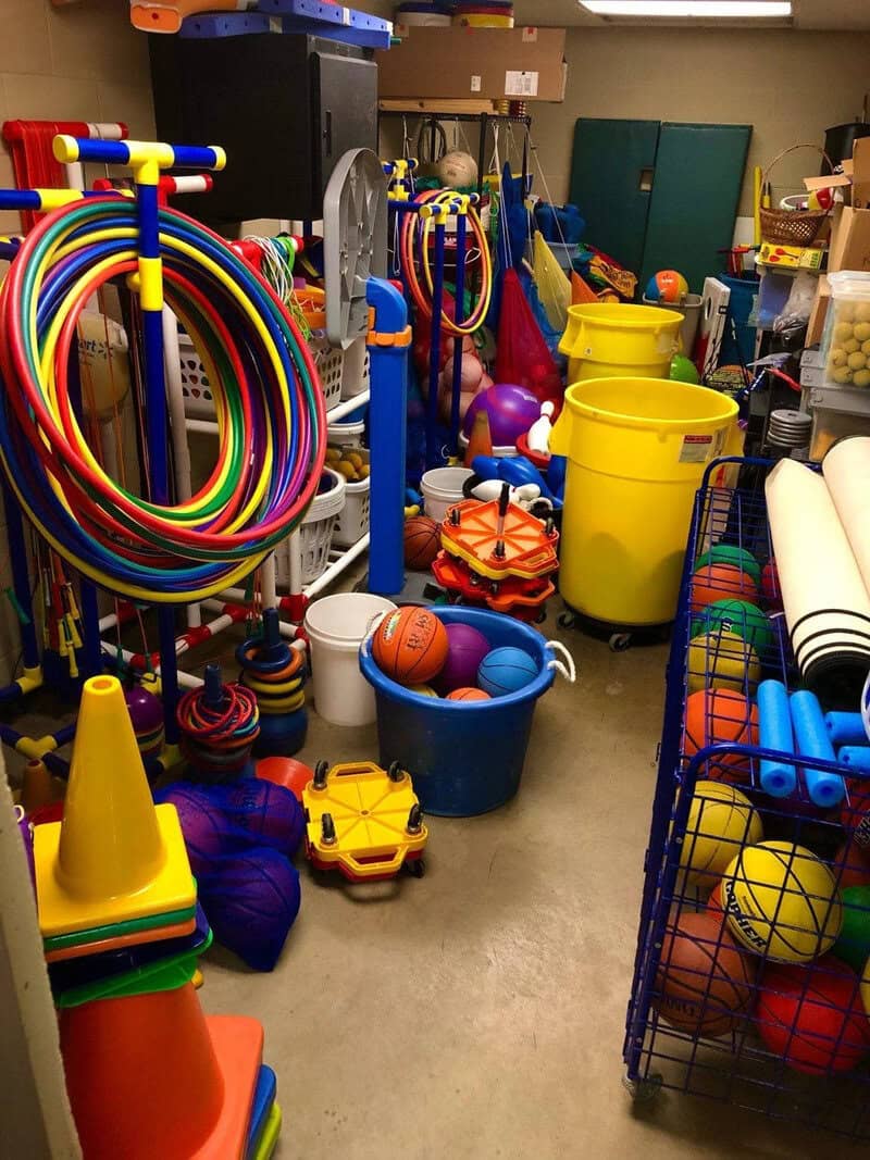 Colorful children's toys and sports equipment in a storage room.