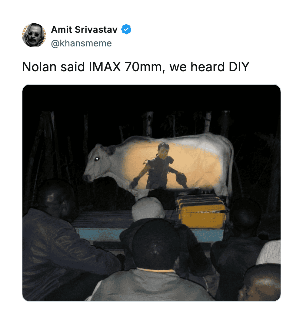 People watching a homemade outdoor movie projection of a boy with a sword.