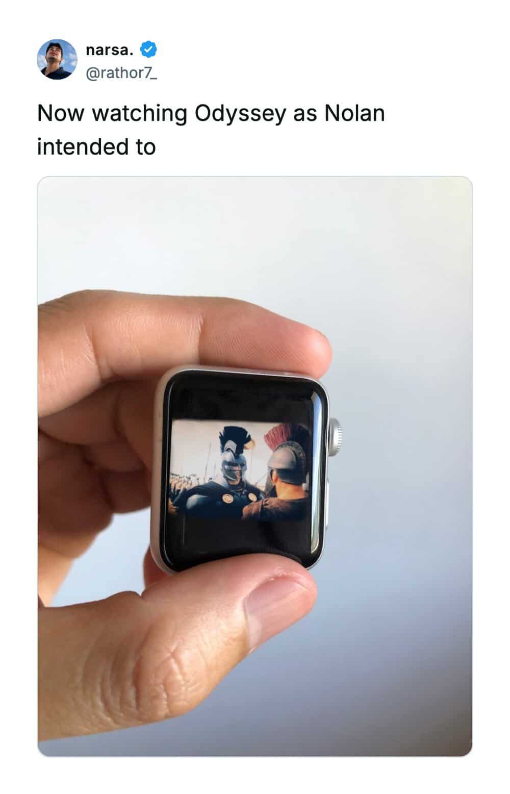 Person holding a smartwatch showing a scene from Odyssey.