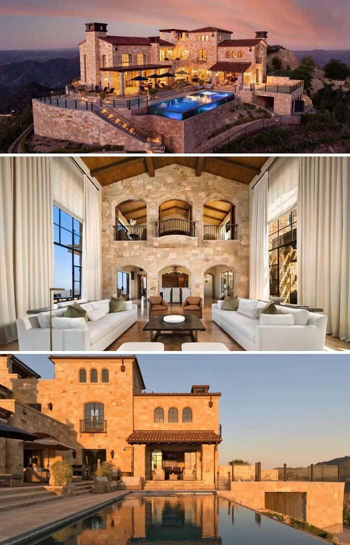 Luxury mansion with pool on hillside at sunset, overlooking mountains.
