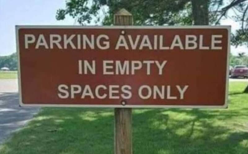 Parking available in empty spaces only sign.