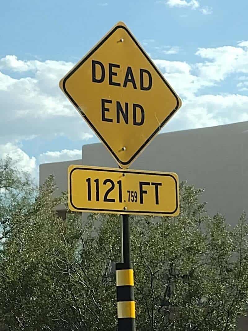 Dead end sign with additional sign showing 1121.759 feet to the end.