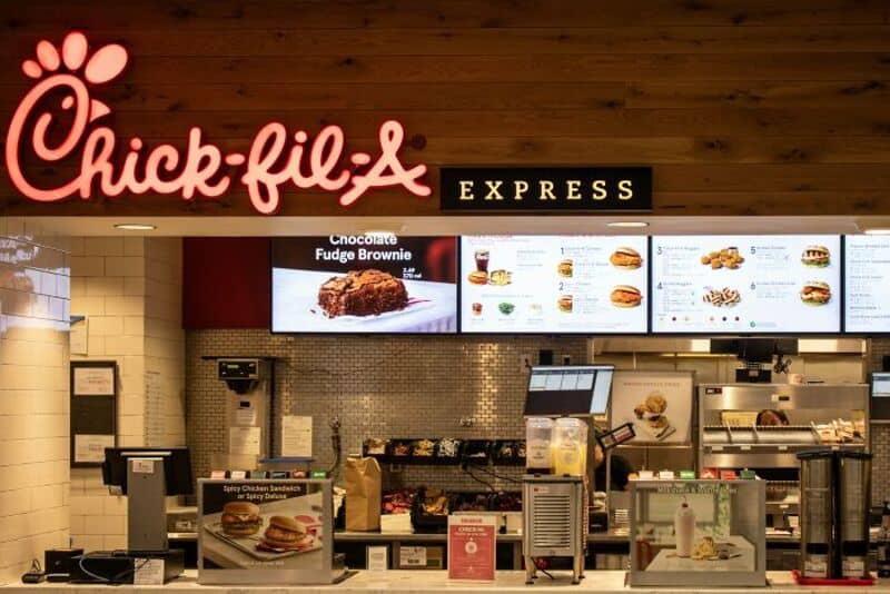 Chick-fil-A Express counter with menu boards and ordering area.