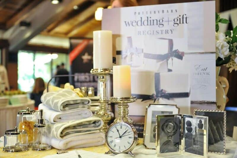 Wedding gift registry display with candles, framed photos, and a clock.