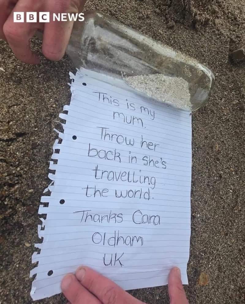 Note in a bottle on sand with handwritten message about a mum.