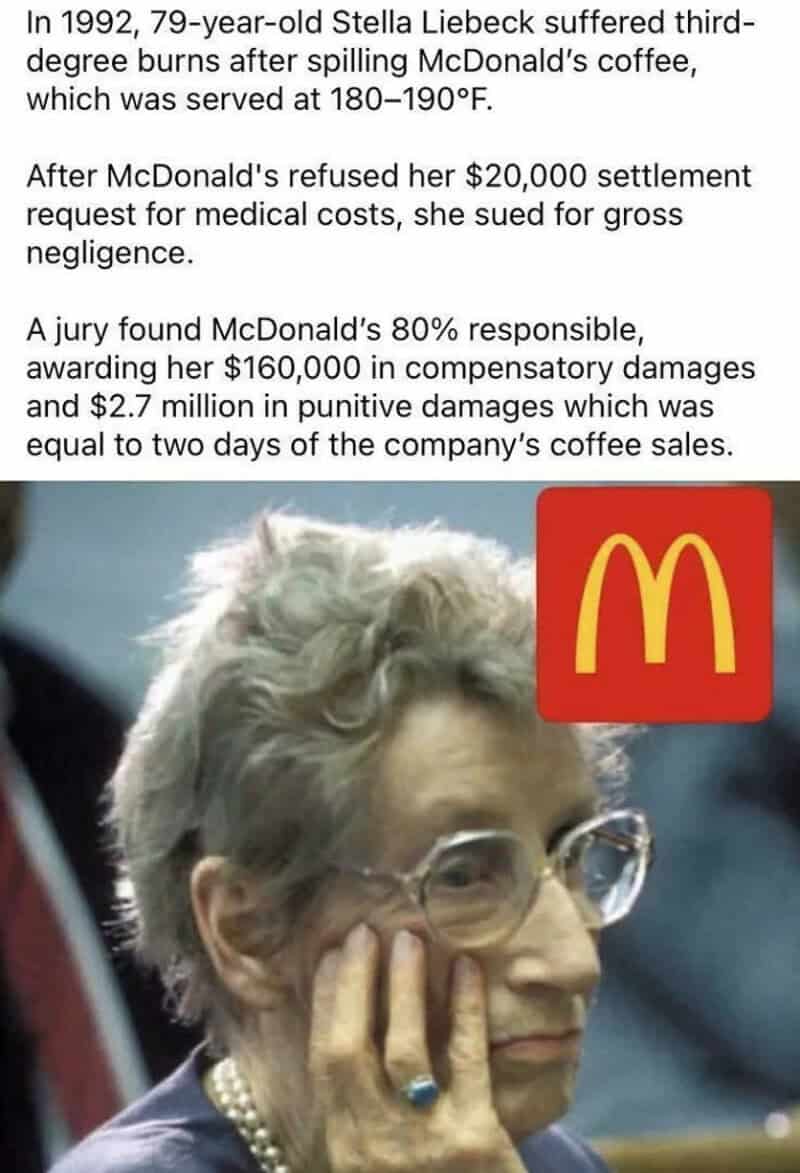 Elderly woman with glasses and pearl necklace, resting her face on her hand, in front of McDonald's.