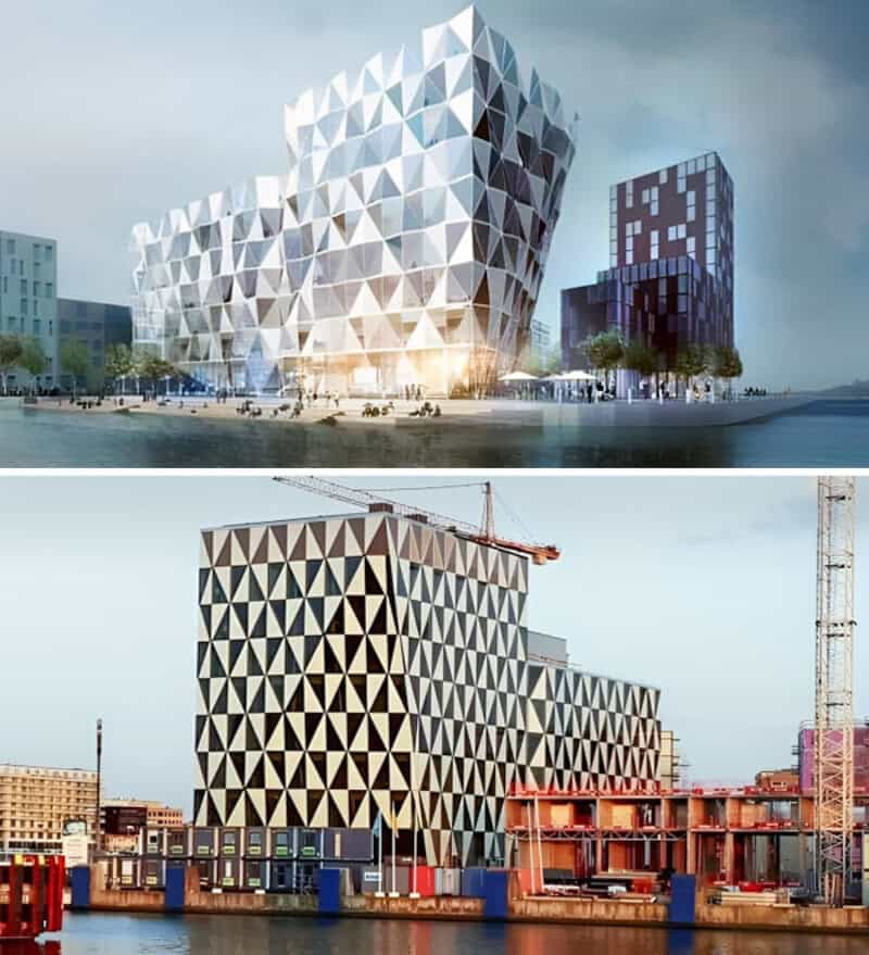 Futuristic building with geometric facade, under construction, with cranes nearby.