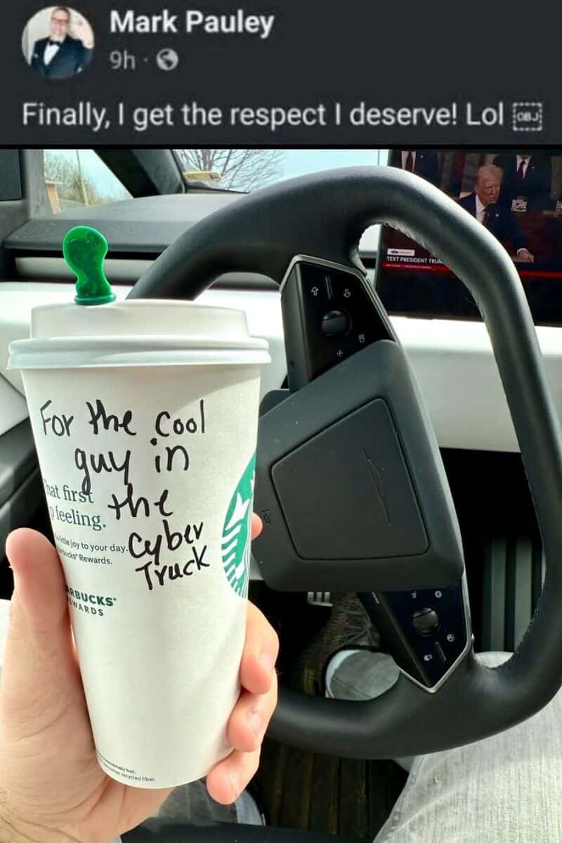 Person holding a Starbucks cup with a note, inside a vehicle.