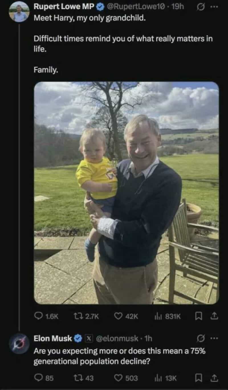 A man holding a young child outdoors with a tree and cloudy sky in the background.