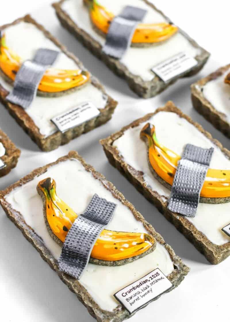 Decorative bread slices with banana and gray strap, labeled 'Crumbcakes 2015'.
