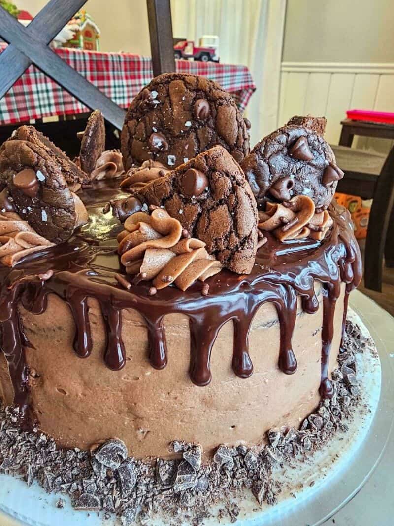 Chocolate cake with cookies and chocolate drizzle, decorated with cookies on top.