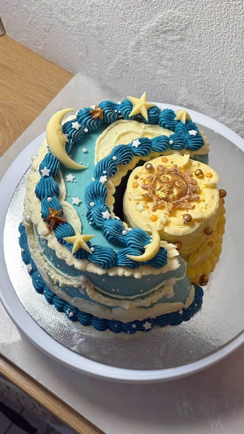 Number 3 cake with blue, yellow, and white decorations, stars, moons, and a lion on top.