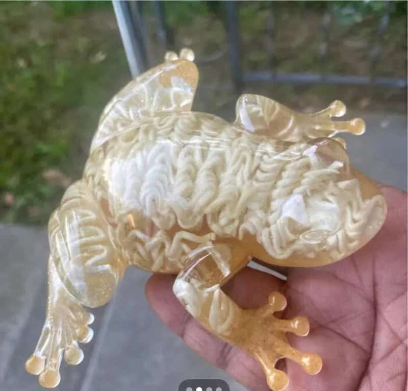Close-up of a glass gecko with detailed textures and transparent limbs.