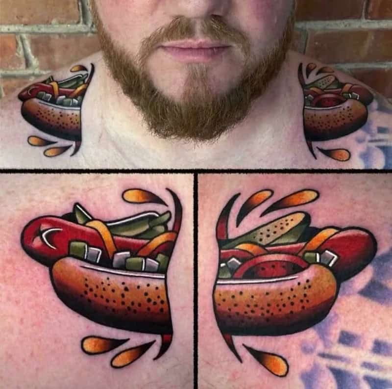 Tattoo of a hot dog with various toppings on man's chest and shoulders.
