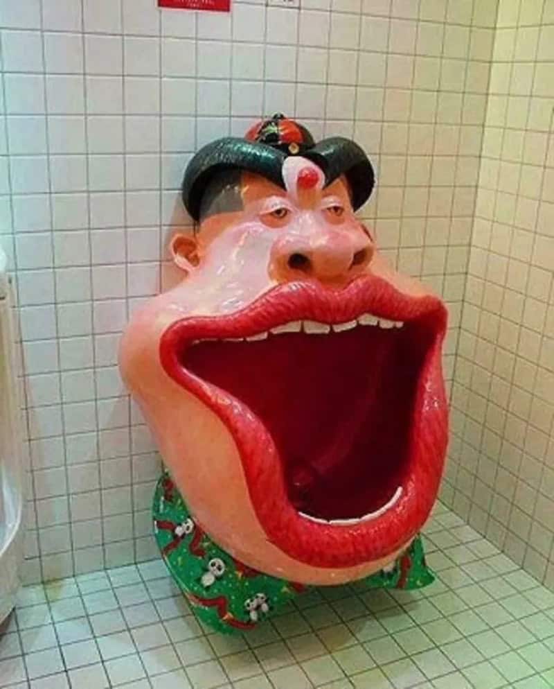 Large cartoonish face with big open mouth, red lips, and exaggerated features.