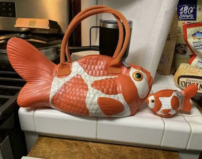 Fish-shaped bag and smaller fish-shaped item on a kitchen counter.