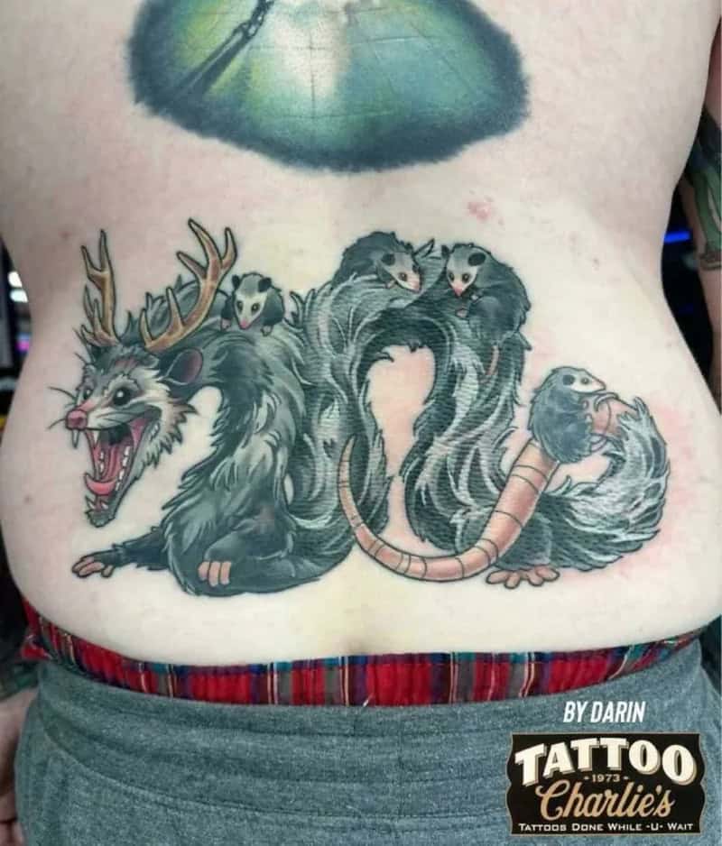 Tattoo of a rat, a mouse, a squirrel, and a ferret with a parasol above them.