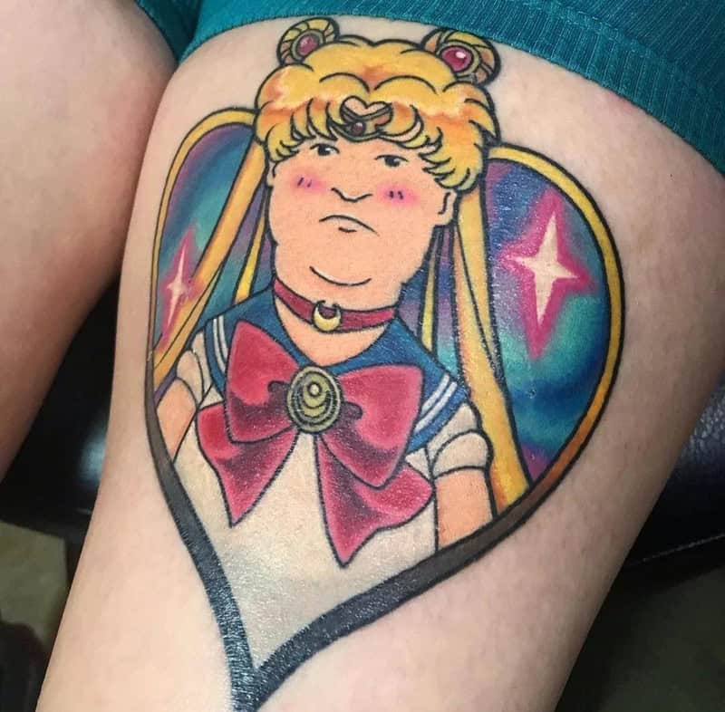 Tattoo of Sailor Moon with a humorous, exaggerated face and blush on cheeks.