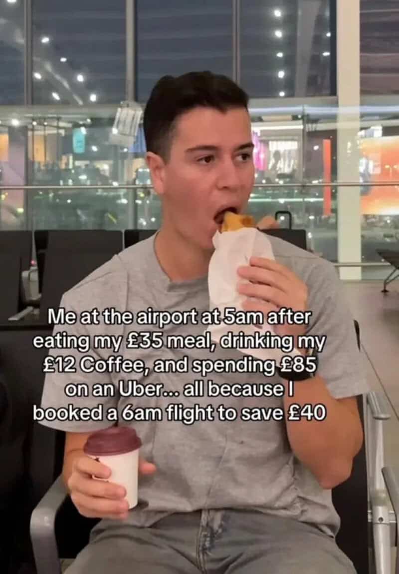 Young man at airport eating a meal with a drink, caption about travel expenses.