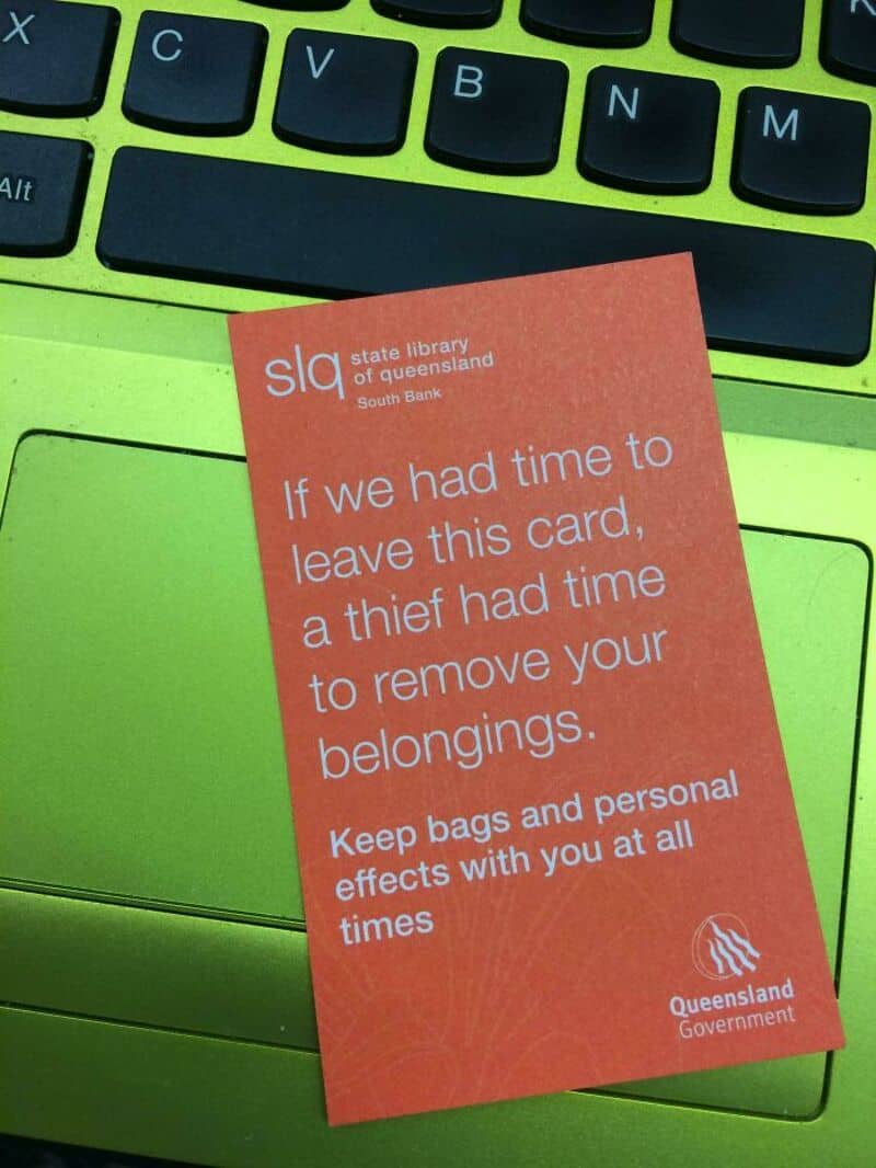 Queensland Library card with theft warning message on a green keyboard.