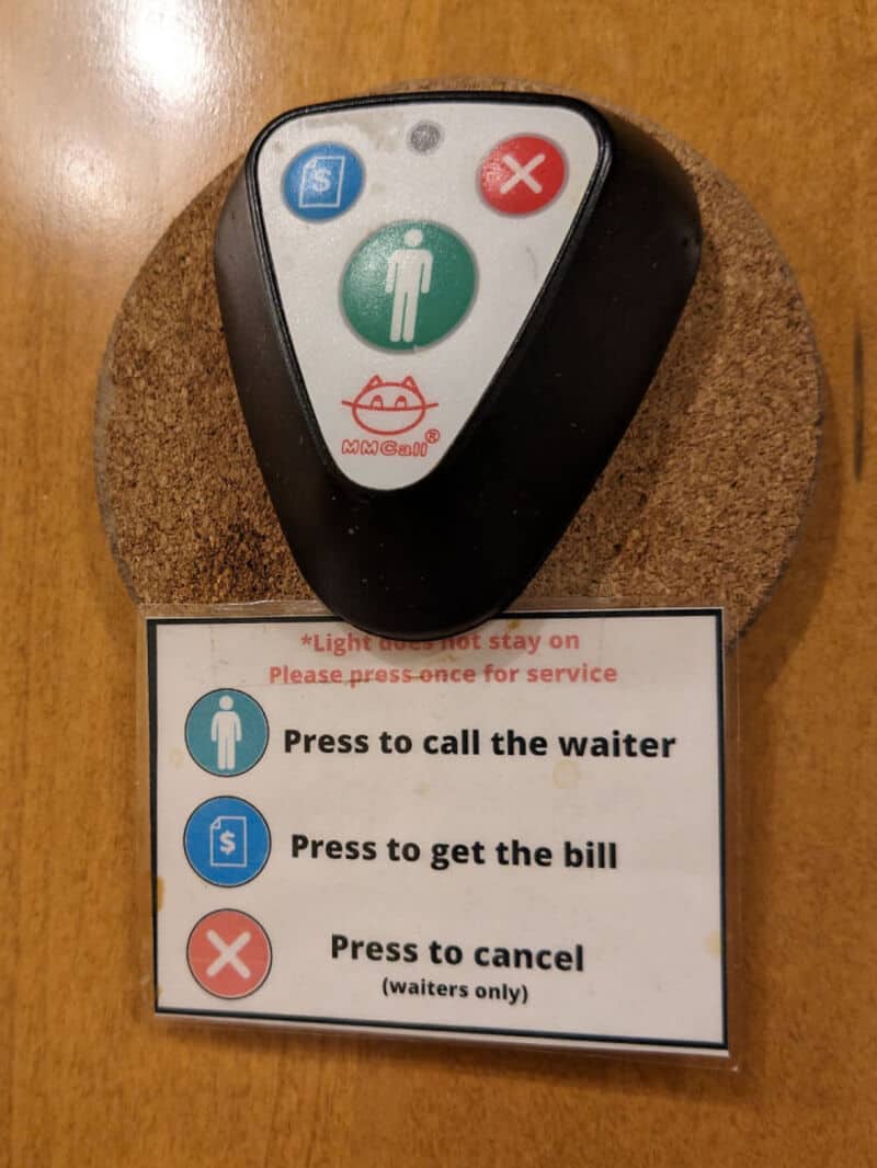 Touchless restaurant pager with instructions for calling waiter, billing, and canceling.