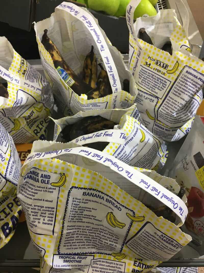 Banana bread wrapped in yellow and white packaging with banana illustrations.