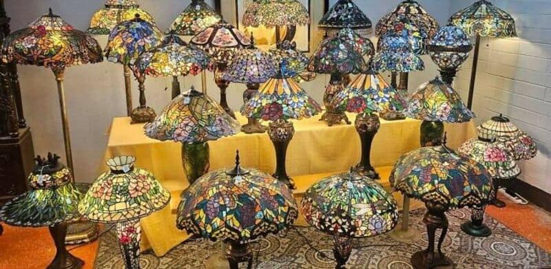 Collection of colorful Tiffany-style stained glass lamps on display.