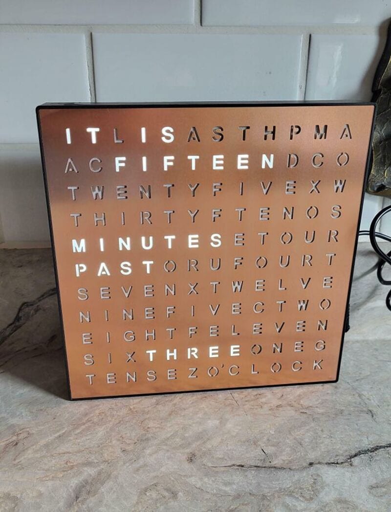 Decorative wall art with words and numbers related to time and dates.
