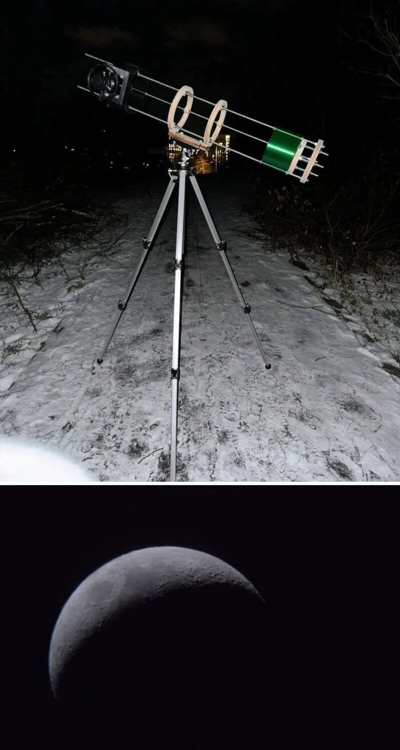 Telescope set up outdoors at night with moon in the sky.