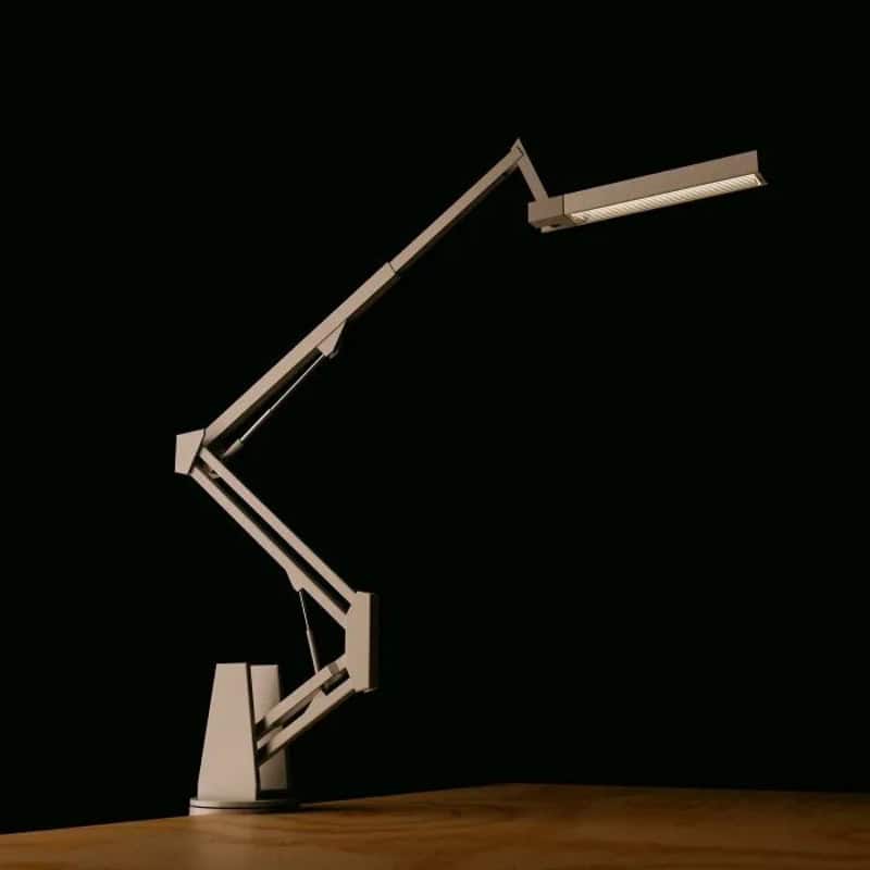 Modern adjustable desk lamp with a sleek design on a wooden surface.
