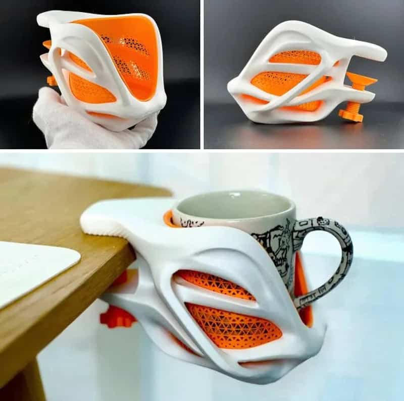 3D-printed mug holder with white and orange design, holding a mug.