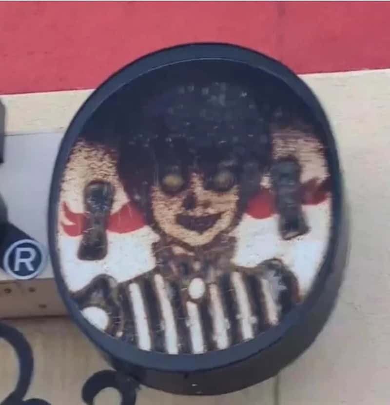 Coffee cup with creepy clown face design on the surface.