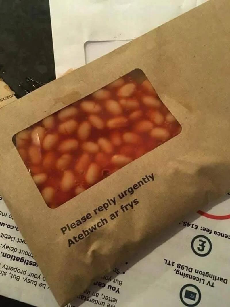 Takeout container with beans and sauce, urgent reply requested.