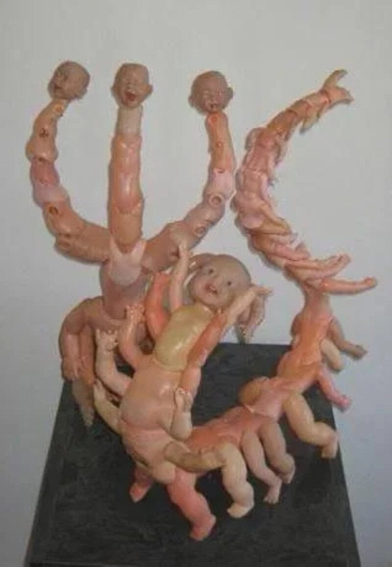 Collection of dismembered doll parts arranged in a creepy display.