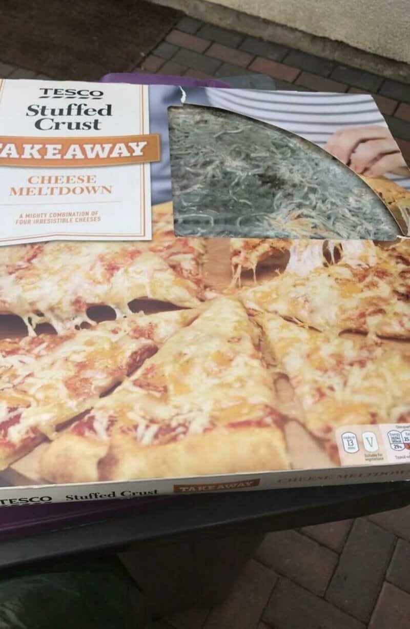 Tesco stuffed crust pizza box with a missing slice, showing the pizza inside.