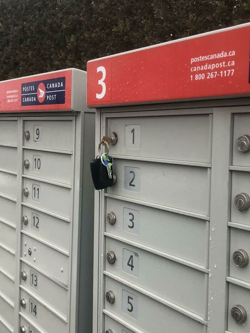 Mailboxes with a lock on mailbox 1, post office sign, and the number 3.