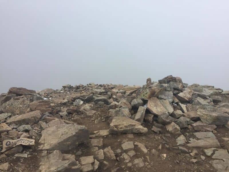 Rocky terrain with foggy, unclear background, no visible landmarks.