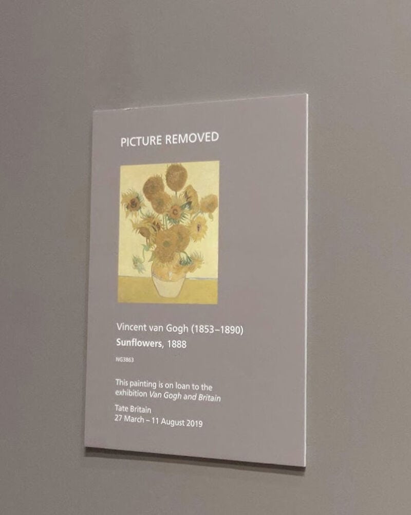 Sign with 'PICTURE REMOVED' over Vincent van Gogh's Sunflowers painting.