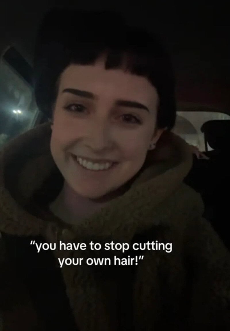 Smiling person with short dark hair and a scarf, quote: "you have to stop cutting your own hair!".
